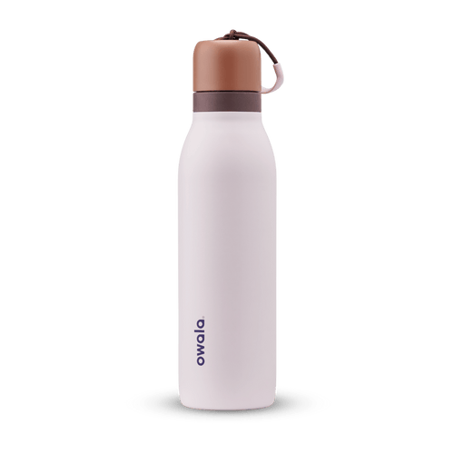 FreeSip Twist 18oz in Sleepy Lavender, soft pale lavender insulated water bottle with copper-orange twist cap, dark plum twist cap accent band, and pink carry string with brown grip
